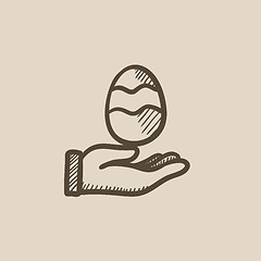 Image showing Hand holding easter egg sketch icon.