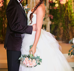 Image showing Bride and groom holding hands close up no face