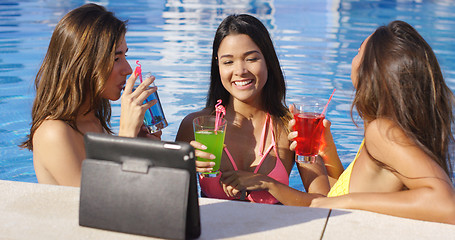 Image showing Three young women having fun taking selfies