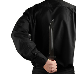 Image showing standing man in black with knife for backs