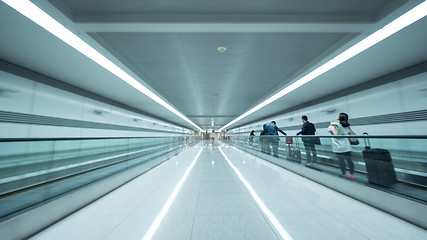 Image showing Tunnel at Seoul airport with people on flat escalator