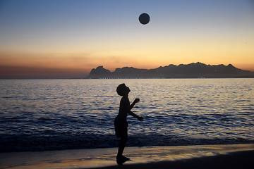 Image showing Playing soccer on the beach sunset