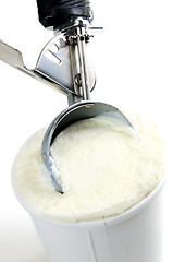 Image showing Tub of vanilla ice cream with a scoop