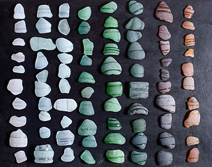 Image showing bottle necks glass pieces polished by the sea