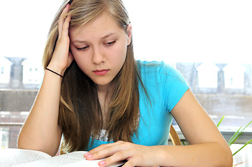 Image showing Teenage girl studying with textbooks