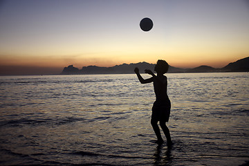 Image showing Playing soccer on the beach sunset
