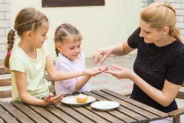 Image showing Mother pours into the handle daughters confectionery Powder for cupcakes