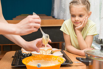 Image showing My daughter looks like mom prepares the blank for baking Easter cakes