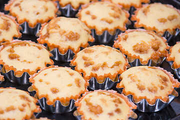 Image showing A view of several freshly baked cakes in metal tins