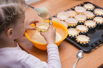 Image showing Daughter holds the mold for the cake, while my mother draws the dough from the bowl