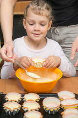Image showing Daughter holds the mold for the cake, while my mother draws the dough from the bowl
