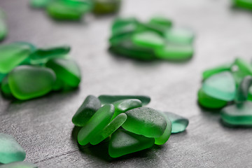 Image showing green pieces of glass polished by the sea