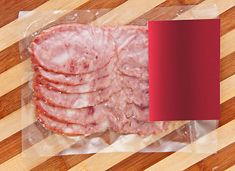 Image showing sliced meat packaged on plate