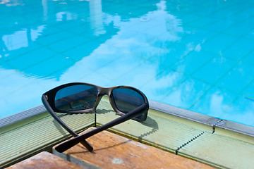 Image showing Sunglasses by the pool