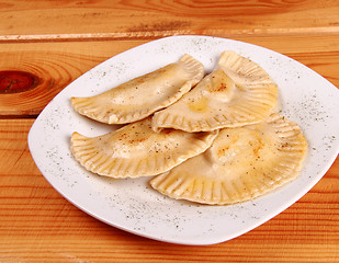 Image showing Cooked raviolli on a shiny white plate