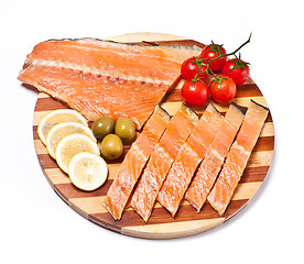 Image showing fresh red fish fillet on plate with vegetables