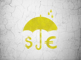 Image showing Safety concept: Money And Umbrella on wall background