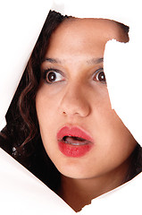 Image showing Woman looking through hole in paper.