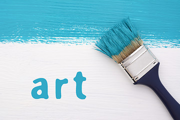 Image showing Stripe of turquoise paint, paintbrush and the word ART