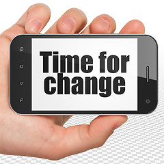 Image showing Time concept: Hand Holding Smartphone with Time for Change on display