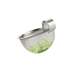 Image showing Tea strainer loaded with green tea