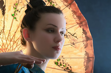 Image showing Portrait of a young woman with a Chinese umbrella