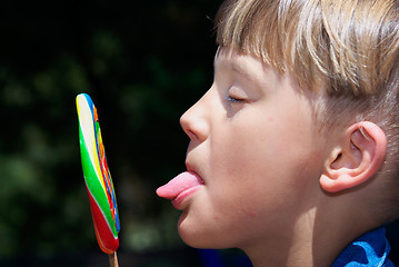 Image showing boy licking a lollipop
