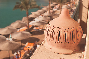 Image showing sunny beach with umbrellas and sunbeds on the sea