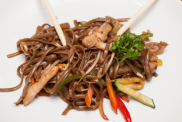 Image showing buckwheat noodles with vegetables and sticks isolated on white