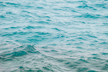 Image showing Photo closeup of beautiful clear turquoise sea ocean water surface with ripples low waves on seascape background, horizontal picture