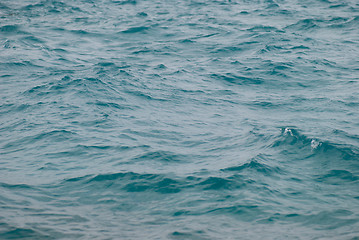 Image showing Photo closeup of beautiful clear turquoise sea ocean water surface with ripples low waves on seascape background, horizontal picture