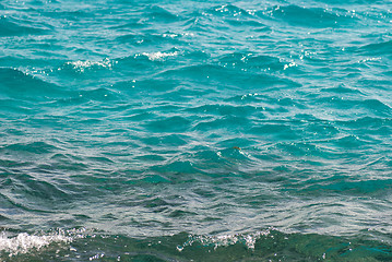 Image showing Photo closeup of beautiful clear turquoise sea ocean water surface with ripples low waves on seascape background, horizontal picture