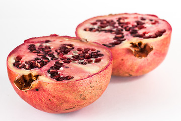 Image showing two halfs ripe pomegranate fruit isolated on white background cutout