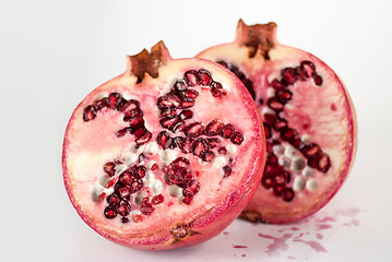 Image showing two halfs ripe pomegranate fruit isolated on white background cutout