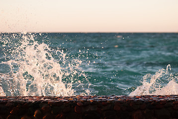 Image showing Photo closeup of beautiful clear turquoise sea ocean water surface with ripples and bright splash on seascape background, horizontal picture