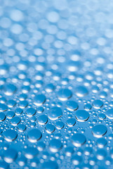 Image showing close-up of water drops on the blue background 