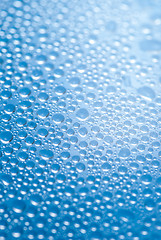 Image showing close-up of water drops on the blue background 