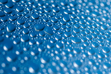 Image showing close-up of water drops on the blue background 