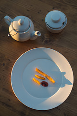 Image showing French fries with ketchup and on wooden table. Top view sunny evening