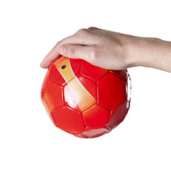 Image showing small soccer red ball in hand. Isolated