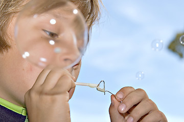 Image showing boy blowing bubbles