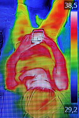 Image showing Infrared image showing the heat emission when woman used smartph