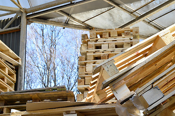 Image showing Waste wood from pallets stacked in the storage room