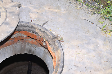 Image showing Concrete cesspit with an open hatch on the ground in the summer