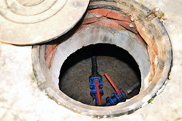 Image showing Concrete cesspit with an open hatch on the ground in the summer