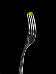 Image showing Fresh green peas on a silver fork
