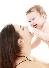Image showing laughing blue-eyed baby playing with mom