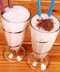 Image showing two cocktails with straw on wooden background