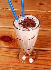 Image showing Milk cocktail and straw in goblet with chocolate