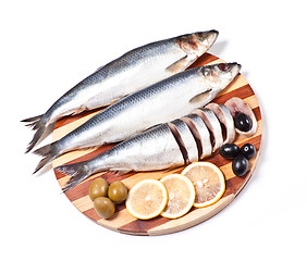 Image showing sliced herring on wooden plate